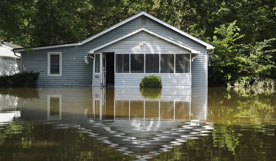 A flooded home is seen in Indianapolis, Sunday, Aug. 16, 2026. (AP Photo/Obed Lamy)
