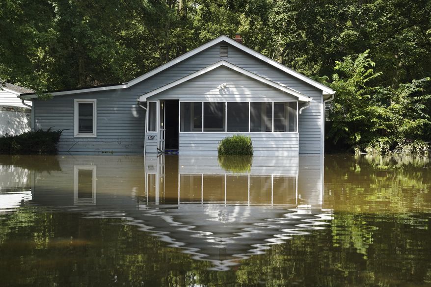 A flooded home is seen in Indianapolis, Sunday, Aug. 16, 2026. (AP Photo/Obed Lamy)