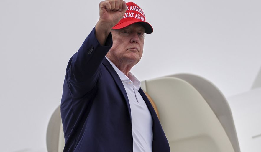 President Donald Trump gestures as he boards Air Force One at Morristown Airport, Sunday, Aug. 16, 2026, in Morristown, N.J. (AP Photo/Julia Demaree Nikhinson)