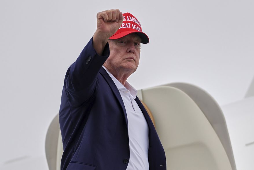 President Donald Trump gestures as he boards Air Force One at Morristown Airport, Sunday, Aug. 16, 2026, in Morristown, N.J. (AP Photo/Julia Demaree Nikhinson)