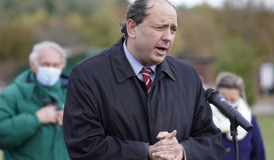 Mass. Democratic state Sen. Jamie Eldridge faces reporters as U.S. Sen. Edward Markey, D-Mass., left, looks on, Monday, Nov. 2, 2020, in Marlborough, Mass., during an event held to encourage voters to cast their ballots for democrats in the 2020 general election. (AP Photo/Steven Senne)