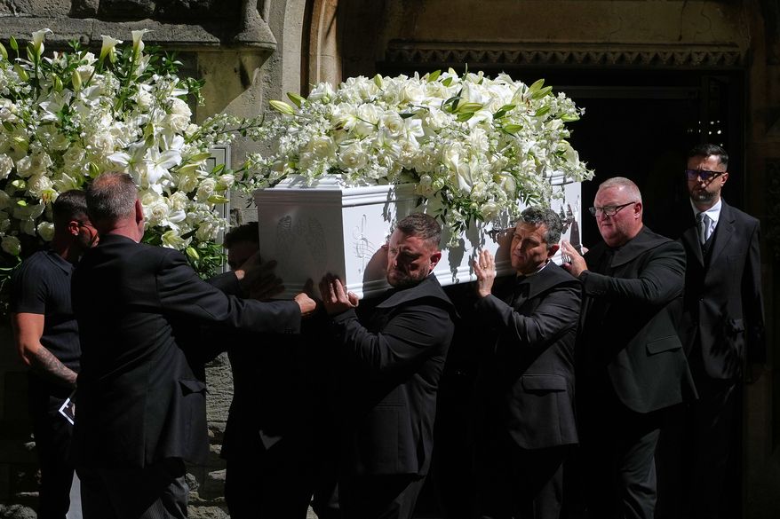The coffin is taken from Swansea Minster following the funeral of Bonnie Tyler in Swansea, Wales, Monday, Aug. 17, 2026. (AP Photo/Alastair Grant)