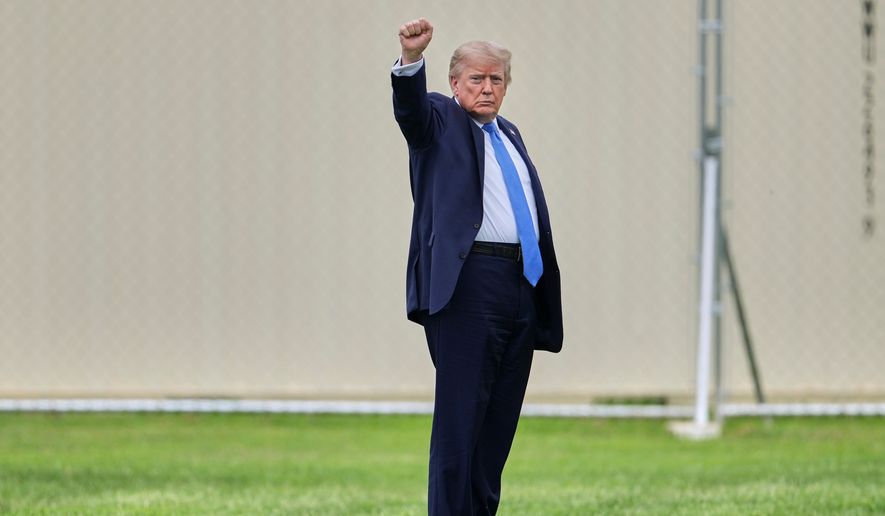 President Donald Trump gestures as he walks to board Marine One on the Ellipse, Friday, Aug. 14, 2026, near the White House in Washington. (AP Photo/Mark Schiefelbein)