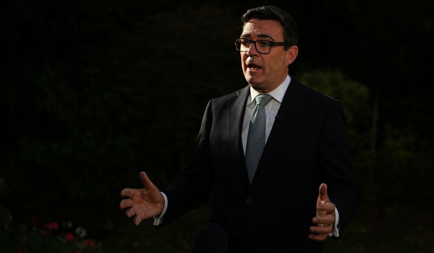 Britain's Prime Minister Andy Burnham speaks to the media after chairing a COBR meeting at Downing Street on the UK's ongoing response to extreme heat, wildfires and drought in London, Wednesday, Aug. 12, 2026.(AP Photo/Kin Cheung, Pool)