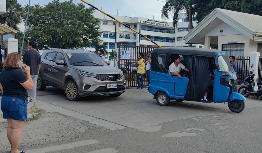 Vehicles exit the Ateneo de Zamboanga University following a shooting incident in Zamboanga, southern Philippines Tuesday, Aug. 18, 2026. (AP Photo) CORRECTION: Corrects date and day