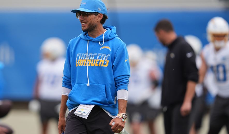 Los Angeles Chargers offensive coordinator Mike McDaniel smiles during an NFL football training camp Wednesday, Aug. 5, 2026, in San Diego. (AP Photo/Gregory Bull)