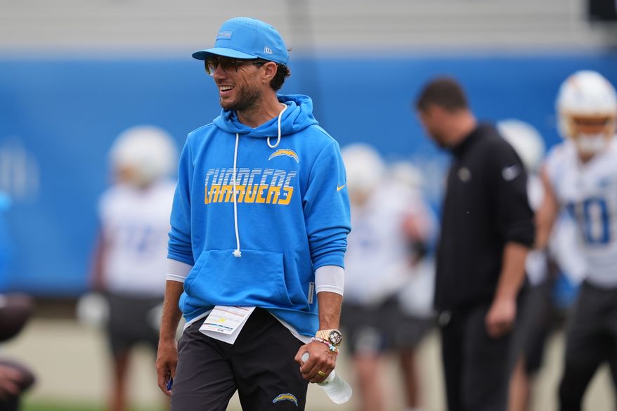 Los Angeles Chargers offensive coordinator Mike McDaniel smiles during an NFL football training camp Wednesday, Aug. 5, 2026, in San Diego. (AP Photo/Gregory Bull)