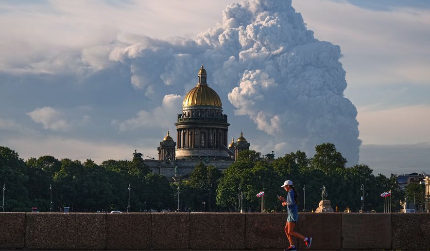 FILE - Smoke rises following a Ukrainian drone attack on a warehouse for online retailer Wildberries in St. Petersburg, Russia on Friday, July 24, 2026, with St. Isaac's Cathedral seen in foreground. (UGC via AP, File)