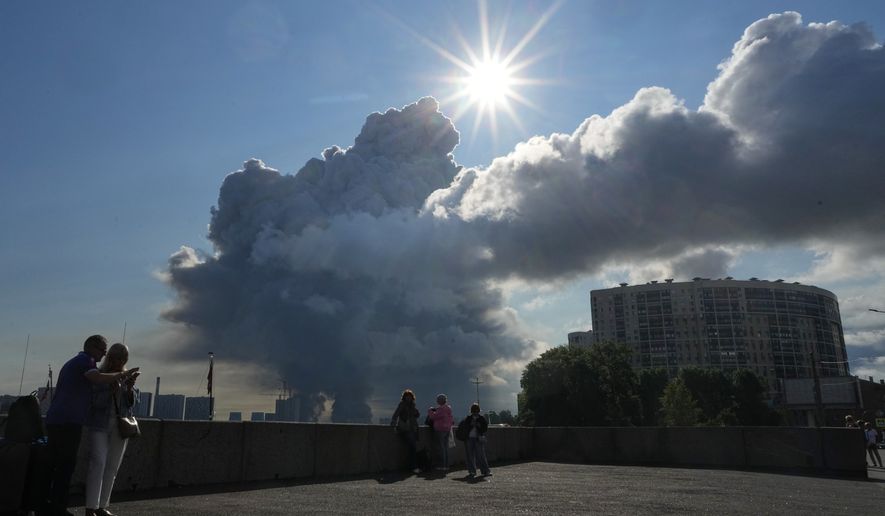 FILE - Smoke rises following a Ukrainian drone strike on a warehouse belonging to online retailer Wildberries, in St. Petersburg, Russia, on Friday, July 24, 2026. (UGC via AP, File)