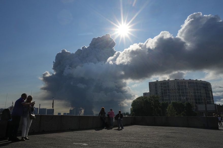 FILE - Smoke rises following a Ukrainian drone strike on a warehouse belonging to online retailer Wildberries, in St. Petersburg, Russia, on Friday, July 24, 2026. (UGC via AP, File)