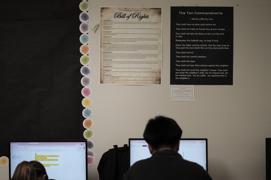 Students work under Ten Commandments and Bill of Rights posters on display in a classroom at Lehman High School in Kyle, Texas, Oct. 16, 2025. (AP Photo/Eric Gay, file)
