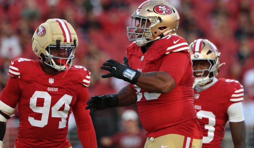 San Francisco 49ers defensive lineman Gracen Halton, middle, celebrates with defensive lineman Romello Height (94) and linebacker Jaden Dugger during the first half of a preseason NFL football game against the Tennessee Titans, Thursday, Aug. 13, 2026, in Santa Clara, Calif. (AP Photo/Jed Jacobsohn)