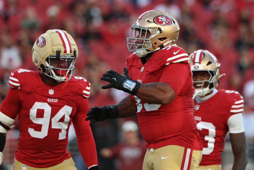 San Francisco 49ers defensive lineman Gracen Halton, middle, celebrates with defensive lineman Romello Height (94) and linebacker Jaden Dugger during the first half of a preseason NFL football game against the Tennessee Titans, Thursday, Aug. 13, 2026, in Santa Clara, Calif. (AP Photo/Jed Jacobsohn)