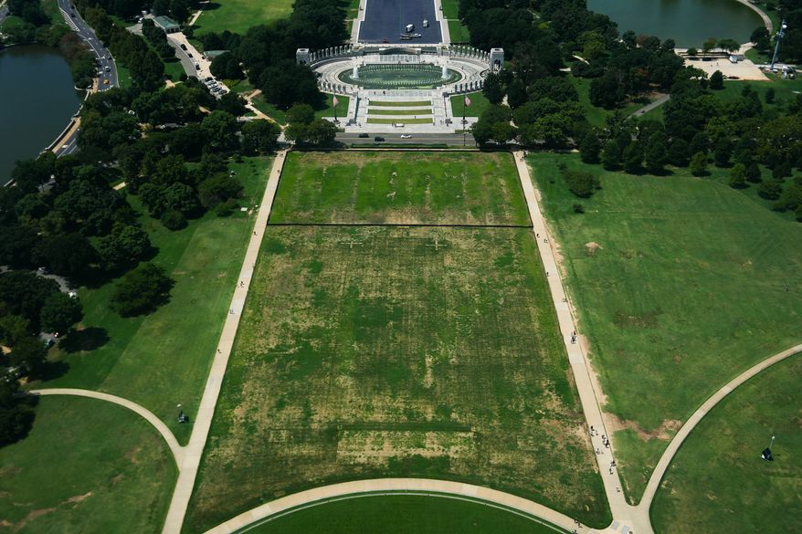 Damaged grass on the National Mall is seen from the Washington Monument, Monday, Aug. 17, 2026, in Washington, with the World War II Memorial in the background. (AP Photo/Julia Demaree Nikhinson)