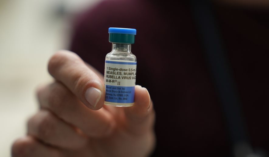 FILE - Dr. Jessica Early holds a vial of the combination measles, mumps and rubella vaccine at Prisma Health Pediatrics in Greer, S.C., March 18, 2026. (AP Photo/Mary Conlon, File)