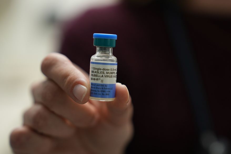 FILE - Dr. Jessica Early holds a vial of the combination measles, mumps and rubella vaccine at Prisma Health Pediatrics in Greer, S.C., March 18, 2026. (AP Photo/Mary Conlon, File)
