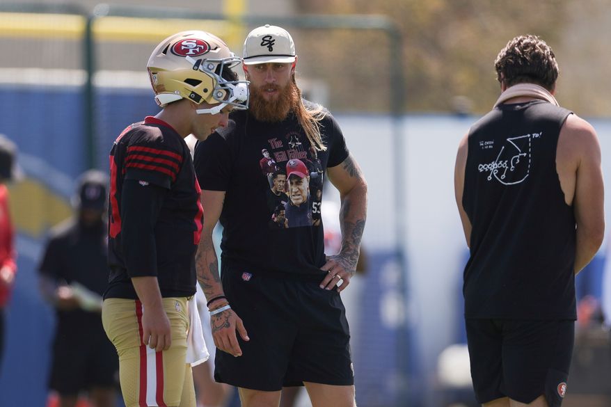 San Francisco 49ers quarterback Brock Purdy (13) talks with tight end George Kittle during a joint NFL football practice with the Los Angeles Chargers, Tuesday, Aug. 18, 2026, in El Segundo, Calif. (AP Photo/Ryan Sun)