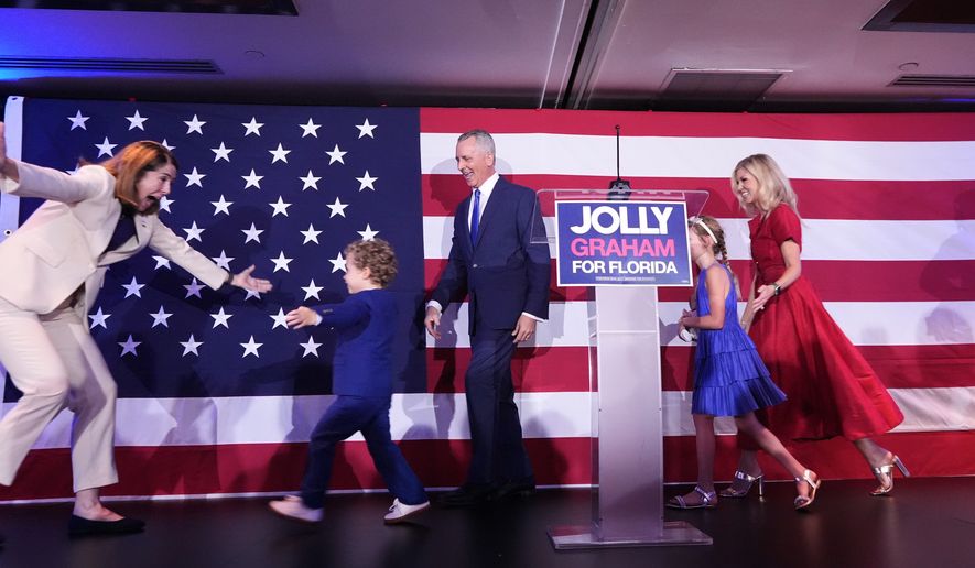 Florida Democratic gubernatorial candidate David Jolly, center, is joined on stage by his family and running mate Gwen Graham, left, during a primary election night watch party, Tuesday, Aug. 18, 2026, in Miami Lakes, Fla. (AP Photo/Rebecca Blackwell)