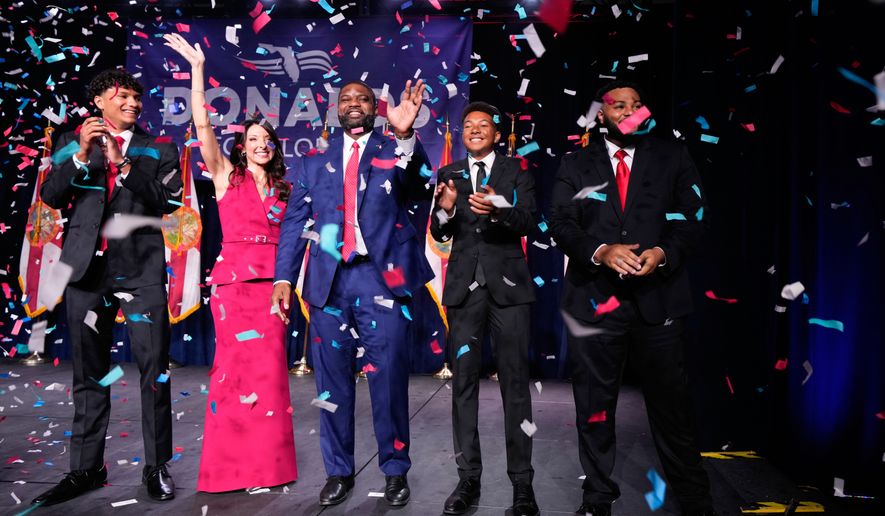 Florida Republican gubernatorial candidate Byron Donalds, center, waves next to his wife Erika, while standing on stage with their children Darin, left, Damon, second from left, and Mason during at a primary election party Tuesday, Aug. 18, 2026, in Orlando, Fla. (AP Photo/John Raoux)
