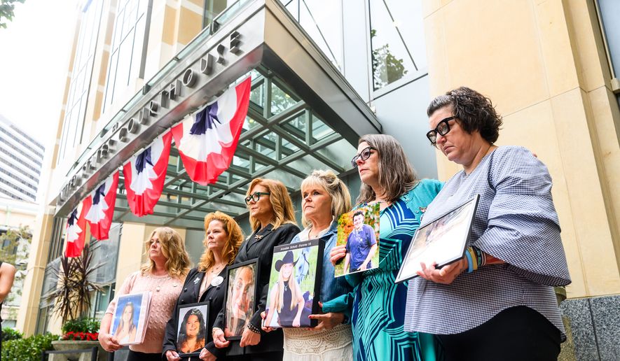 Parents hold pictures of their deceased children during a protest against social media platforms outside the Ronald V. Dellums Federal Building and U.S. Courthouse on Tuesday, Aug. 18, 2026, in Oakland, Calif. (AP Photo/Noah Berger)