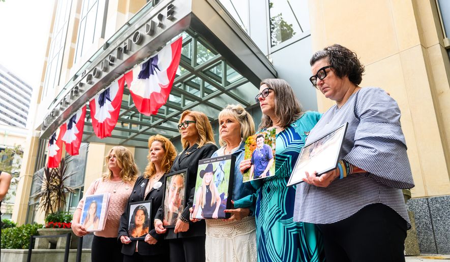Parents hold pictures of their deceased children during a protest against social media platforms outside the Ronald V. Dellums Federal Building and U.S. Courthouse on Tuesday, Aug. 18, 2026, in Oakland, Calif. (AP Photo/Noah Berger)