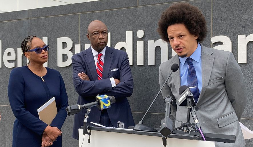 Comedian Eric André, right, speaks at a news conference outside the federal courthouse in Atlanta on Oct. 11, 2022, as his attorneys Allegra Lawrence-Hardy, left, and Richard Deane watch. (AP Photo/Kate Brumback, File)