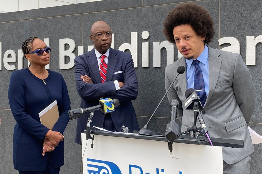 Comedian Eric André, right, speaks at a news conference outside the federal courthouse in Atlanta on Oct. 11, 2022, as his attorneys Allegra Lawrence-Hardy, left, and Richard Deane watch. (AP Photo/Kate Brumback, File)