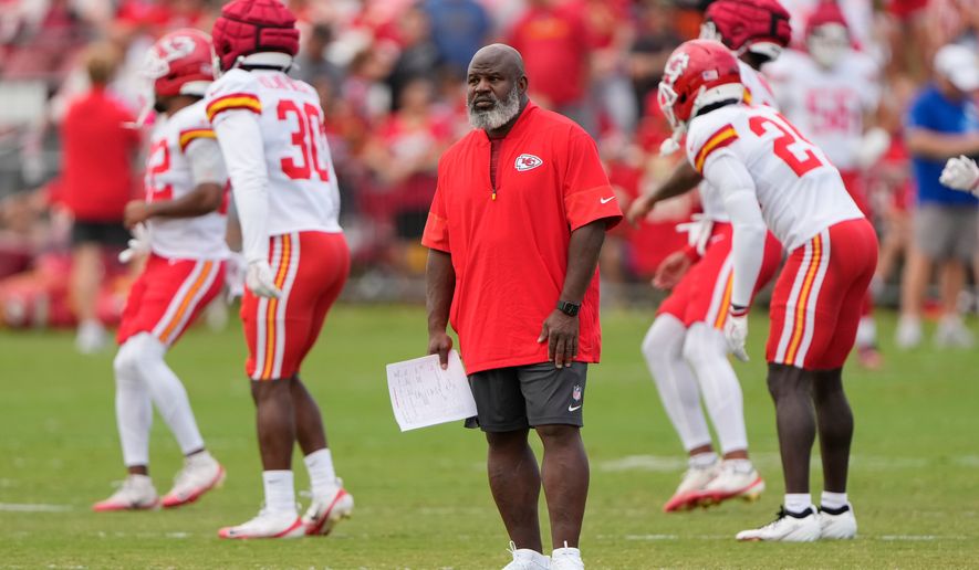 Kansas City Chiefs offensive coordinator Eric Bieniemy watches NFL football training camp Tuesday, Aug. 11, 2026, in St. Joseph, Mo. (AP Photo/Charlie Riedel)