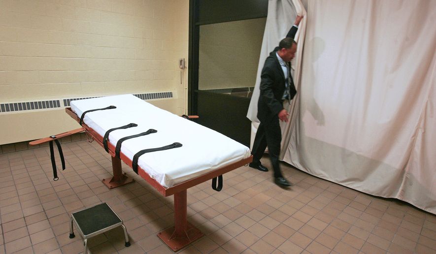FILE – Larry Greene, public information director of the Southern Ohio Correctional Facility, demonstrates how a curtain is pulled between the death chamber and witness room at the prison in Lucasville, Ohio, in Nov., 2005. (AP Photo/Kiichiro Sato, File)