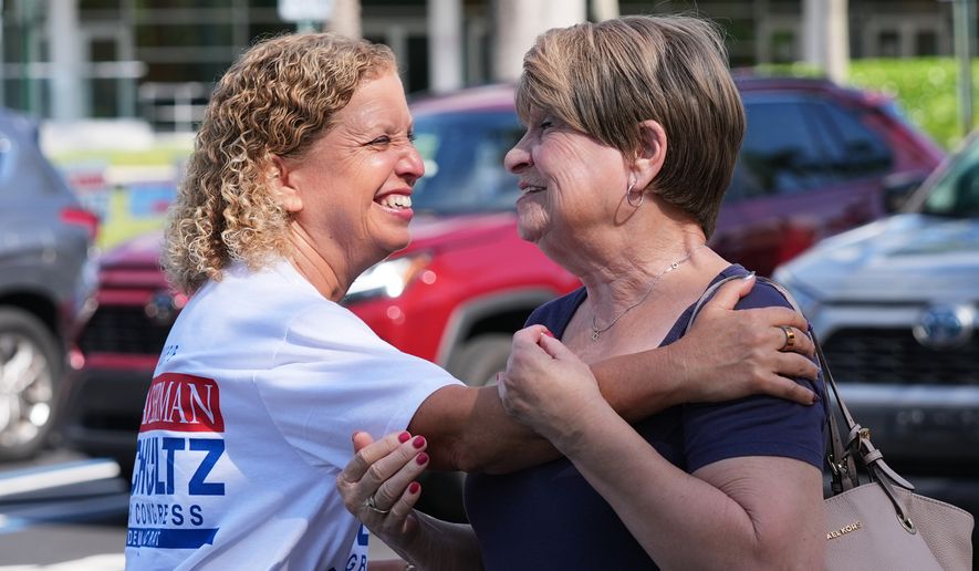 U.S. Rep. Debbie Wasserman Schultz, left, greets voters while campaigning for Florida's 20th congressional district in the Florida primary election, Tuesday, Aug. 18, 2026, in Tamarac, Fla. (AP Photo/Lynne Sladky)