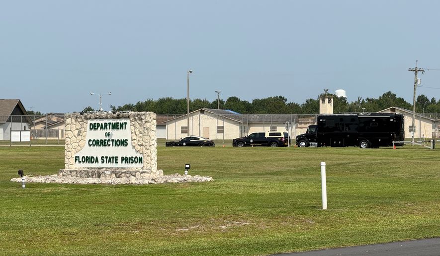 FILE - Law enforcement vehicles sit parked outside the Florida state prison in Starke, Fla., on Tuesday, July 28, 2026. (AP Photo/David Fischer, file)