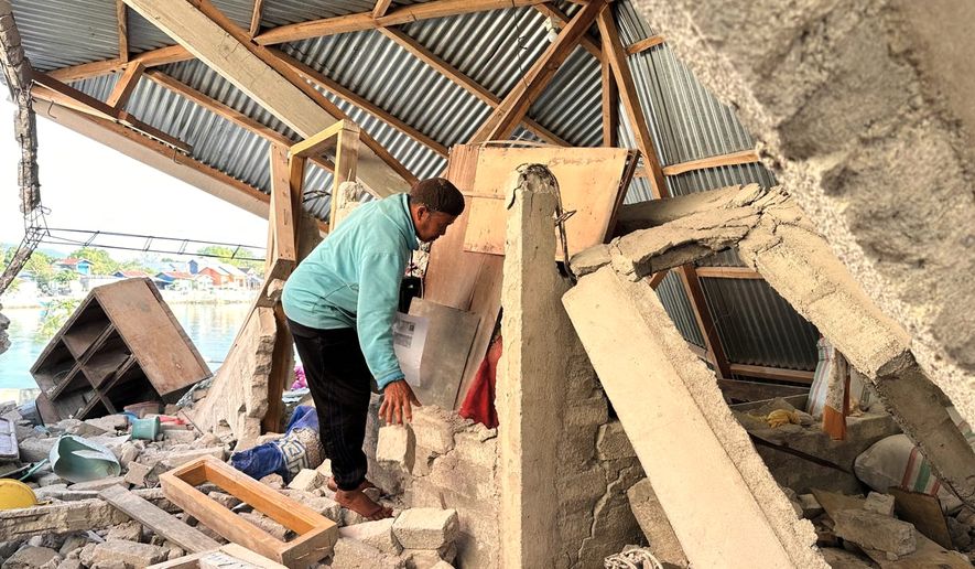 Arshad Hamid, an earthquake survivor, looks for valuable in his damaged house in North Lamba Leda, East Nusa Tenggara province, Indonesia, Wednesday, Aug. 19, 2026. (AP Photo/Firdia Lisnawati)
