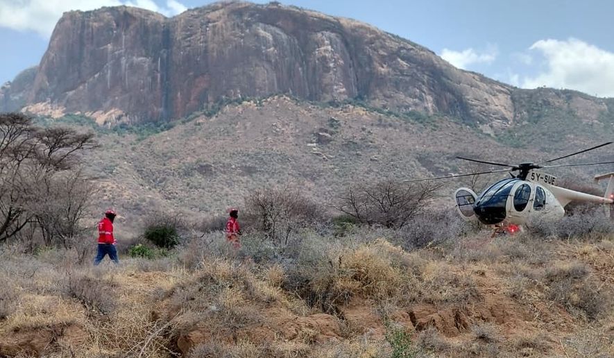 This photo provided by Kenya Red Cross shows Kenya Red Cross emergency response teams during a multi-agency rescue and recovery operation in response to a helicopter crash near Mt. Ololokwe in Samburu, Kenya, Wednesday, Aug. 19, 2026. (Kenya Red Cross via AP) ADDITION: Removes reference to killed tourists