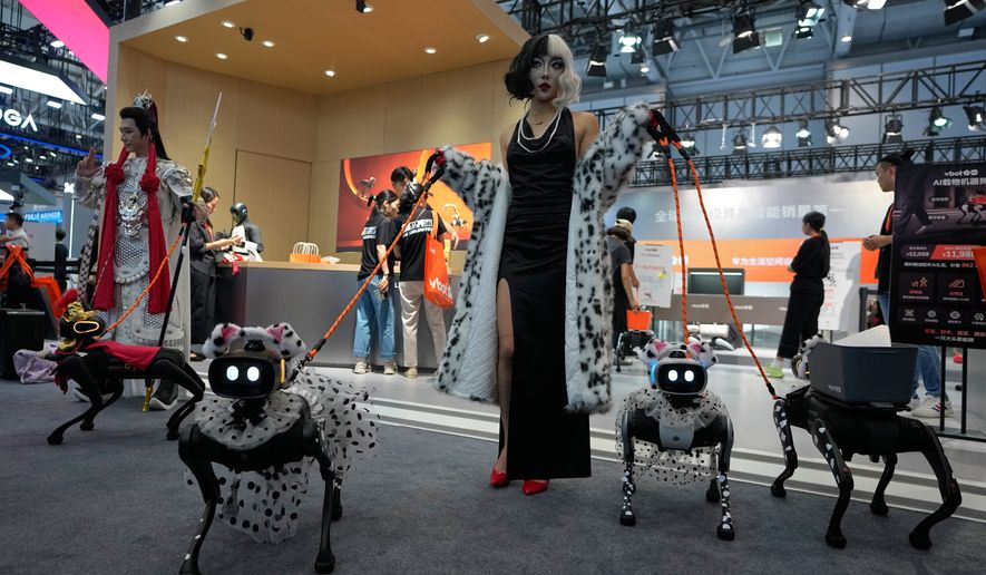 Models showing their robotic dogs with fancy dressing at a booth during the World Robot Conference at the Beiren Yichuang International Convention and Exhibition Centre in Beijing, Wednesday, Aug. 19, 2026. (AP Photo/Andy Wong)