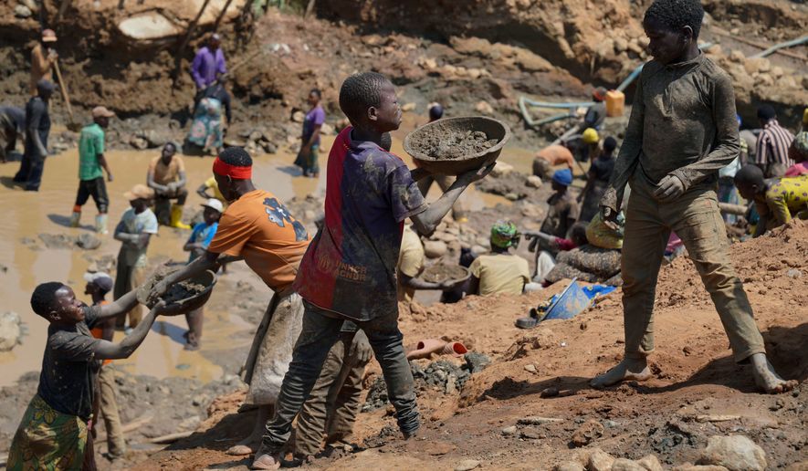 Adults and children search for gold at a mining site in Iga-Barrière, Ituri province, eastern Congo, Friday, Aug. 14, 2026. (AP Photo/Dieudonne Dirole)