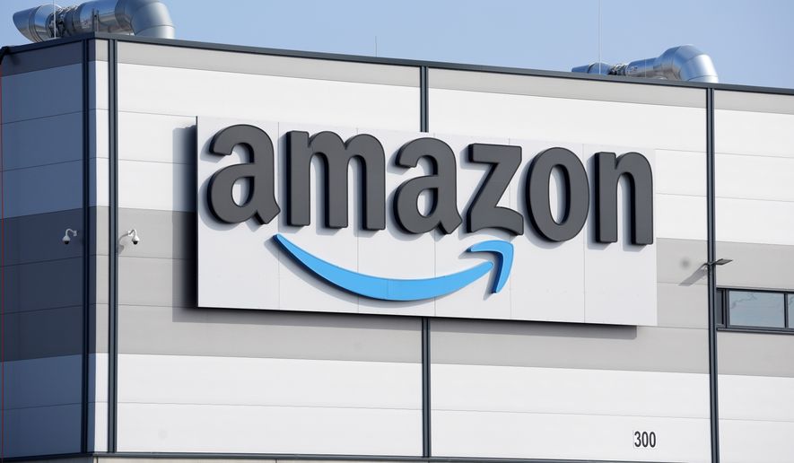 FILE - An Amazon company logo marks the facade of a building, March 18, 2022, in Schoenefeld near Berlin. (AP Photo/Michael Sohn, File)