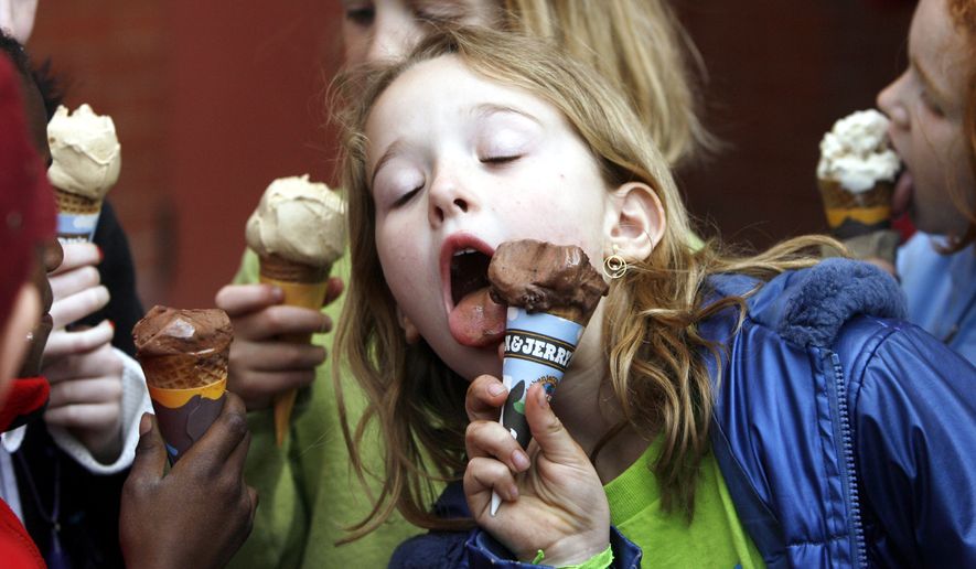 A youngster eats an ice cream cone in front of the Ben & Jerry's ice cream shop in Montpelier, Vt., April 25, 2006. (AP Photo/Toby Talbot, File)