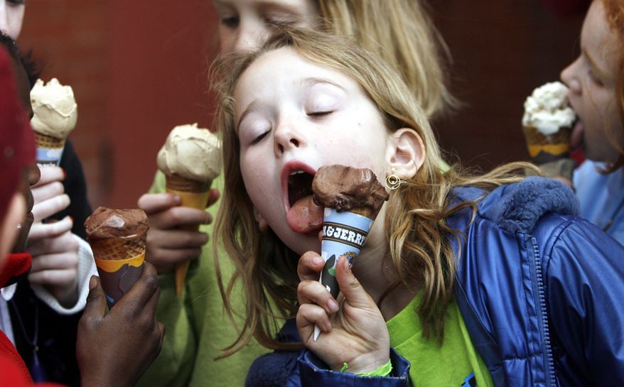 A youngster eats an ice cream cone in front of the Ben & Jerry's ice cream shop in Montpelier, Vt., April 25, 2006. (AP Photo/Toby Talbot, File)