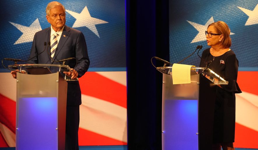 U.S. Rep. Ralph Norman, R-S.C., left, looks on as Sen. Darline Graham, R-S.C., speaks during a debate ahead of the special GOP Senate runoff election to replace the late Sen. Lindsey Graham, R-S.C., in Newberry, S.C., Tuesday, Aug. 18, 2026. (AP Photo/Meg Kinnard)