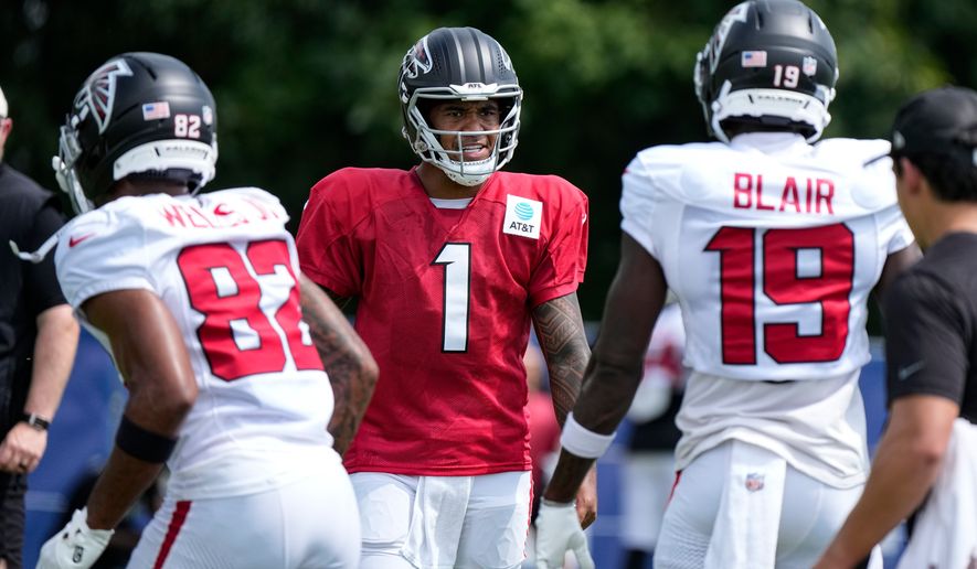 Atlanta Falcons quarterback Tua Tagovailoa (1) cuts between wide receiver Antwane Wells Jr. (82) and wide receiver Chris Blair (19) during a joint practice with the Indianapolis Colts at the team's NFL football training camp in Westfield, Ind., Wednesday, Aug. 19, 2026. (AP Photo/Michael Conroy)