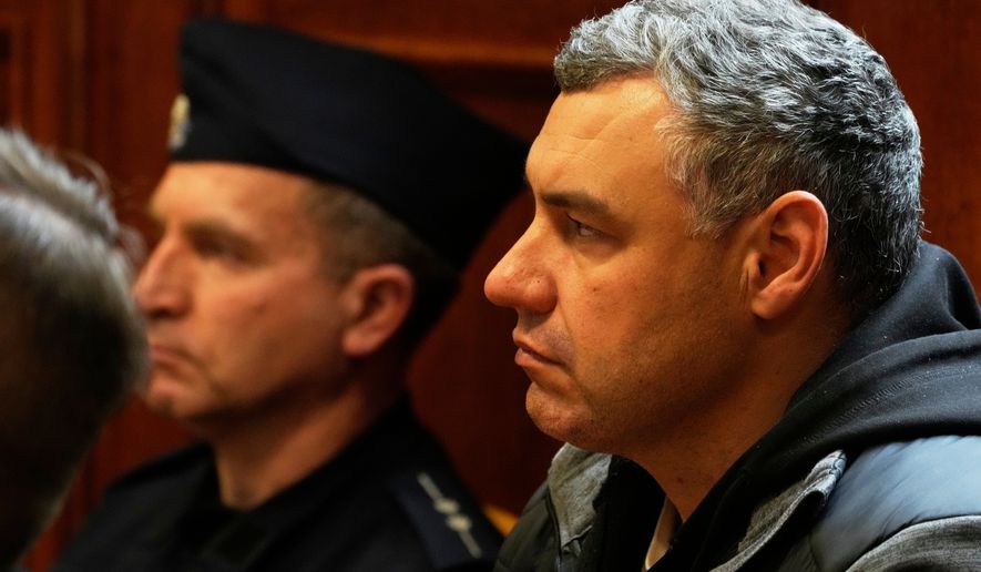 FILE - Ukrainian defendant Volodymyr Zhuravlov, right, listens as a judge announces the decision not to allow for extradition to Germany in courtroom of Warsaw's Regional Court in Warsaw, Poland, Friday, Oct. 17, 2025. (AP Photo/Czarek Sokolowski, File)