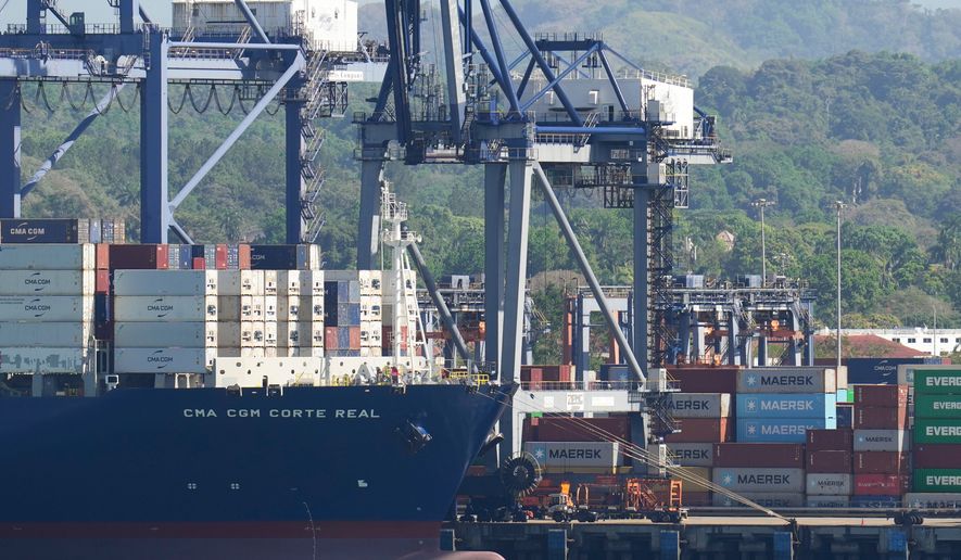 FILE - Cranes load a cargo ship at Panama Canal's Port of Balboa, managed by CK Hutchison Holdings, in Panama City, on Jan. 30, 2026. (AP Photo/Matias Delacroix, File)