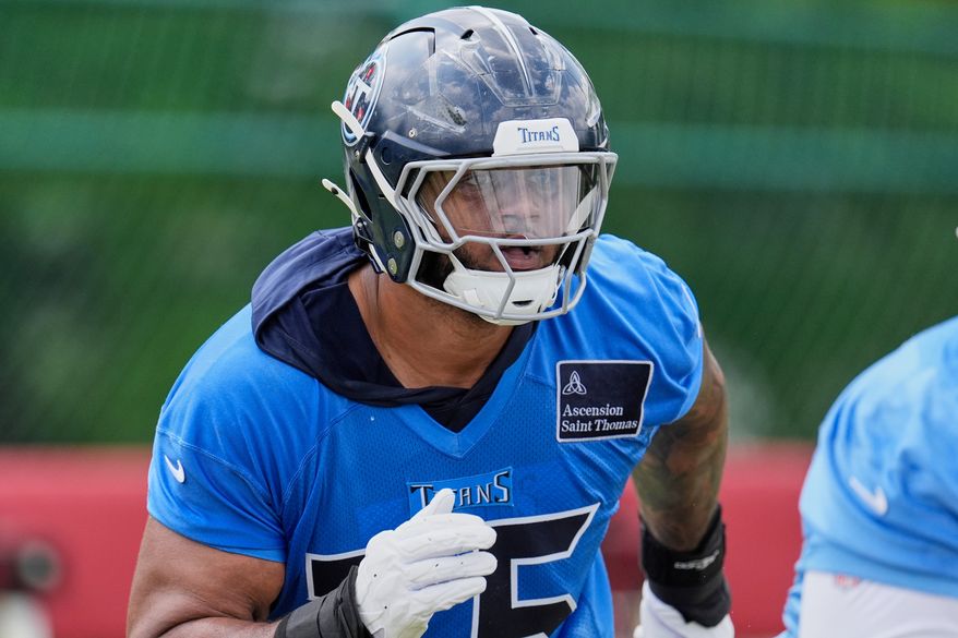 FILE - Tennessee Titans offensive tackle Dan Moore Jr. (75) runs through a drill during an NFL football practice Tuesday, June 3, 2025, in Nashville, Tenn. (AP Photo/George Walker IV, File)