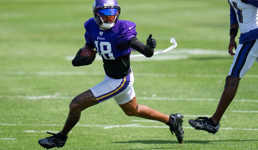 Minnesota Vikings wide receiver Justin Jefferson (18) makes a contested catch and out runs Baltimore Ravens cornerback Bilhal Kone (31) during a joint NFL football practice, Wednesday, Aug 19, 2026, in Eagan, Minn. (Alex Kormann/Minnesota Star Tribune via AP)
