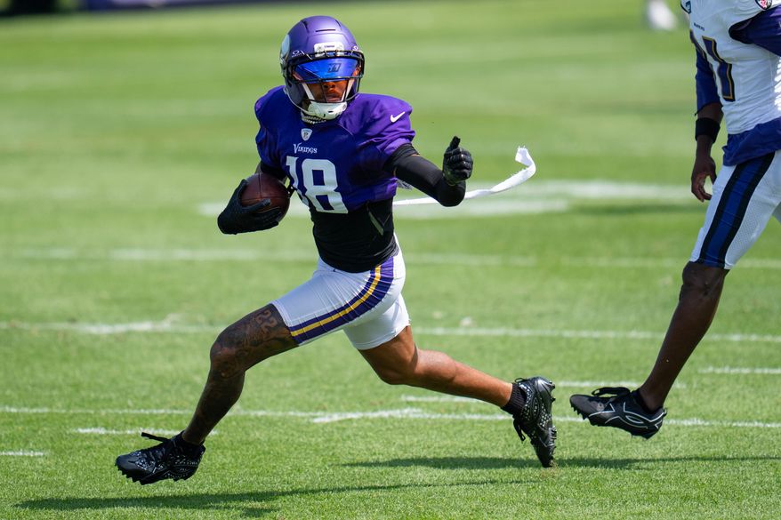 Minnesota Vikings wide receiver Justin Jefferson (18) makes a contested catch and out runs Baltimore Ravens cornerback Bilhal Kone (31) during a joint NFL football practice, Wednesday, Aug 19, 2026, in Eagan, Minn. (Alex Kormann/Minnesota Star Tribune via AP)