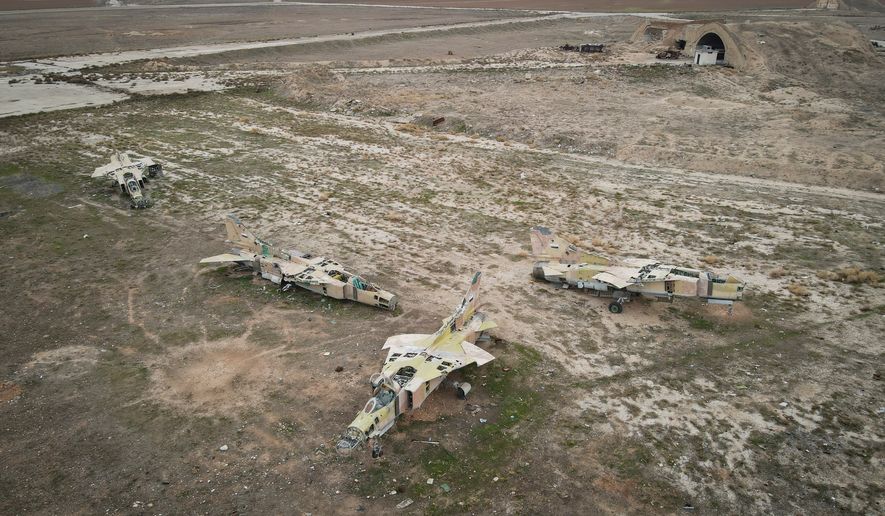 Decommissioned Syrian air force planes are seen at the Abu Duhur military air base east of Idlib, following the takeover of the area by Syrian opposition fighters on Saturday, Dec. 7, 2024. (AP Photo/Omar Albam, File)