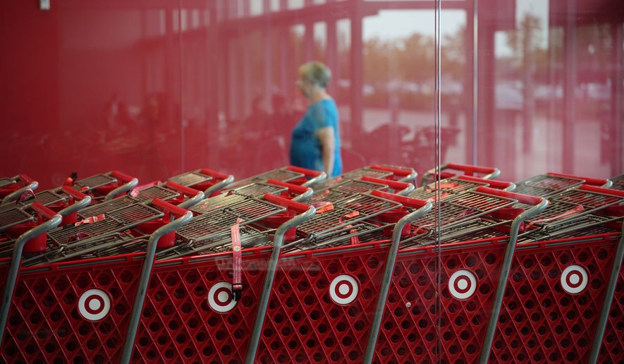 A shopper enters a Target store, Thursday, Aug. 13, 2026, in Woodbury, Minn. (AP Photo/Ellen Schmidt)