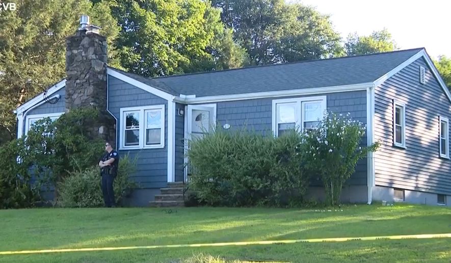 This screen grab made from video provided by WCVB-TV shows a police officer standing guard over a home in Worcester, Mass., Tuesday, Aug. 18, 2026. (WCVB-TV via AP)
