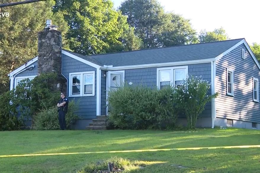 This screen grab made from video provided by WCVB-TV shows a police officer standing guard over a home in Worcester, Mass., Tuesday, Aug. 18, 2026. (WCVB-TV via AP)