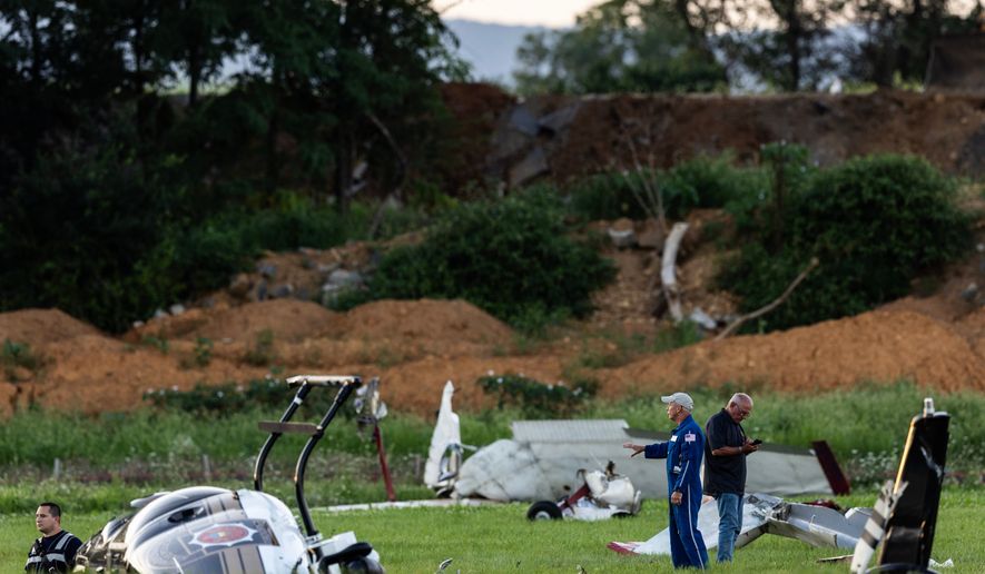 Authorities investigate a crash between a Pennsylvania State Police helicopter and a small plane at the Carlisle airport in Carlisle, Pa. Wednesday, Aug. 19, 2026. (Sean Simmers/The Patriot-News via AP)
